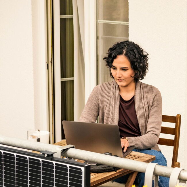 Auf dem Bild sitzt eine interessierte Bürgerin auf der Terasse und stellt über das Kontaktformular der Klimaplan Website eine Kontaktanfrage an das Hessisches Ministerium für Landwirtschaft und Umwelt, Weinbau, Forsten, Jagd und Heimat.